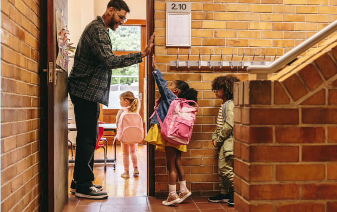 Teacher high-fiving a grade school student