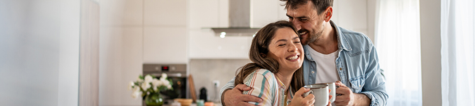 young couple hugging in a modern kitchen